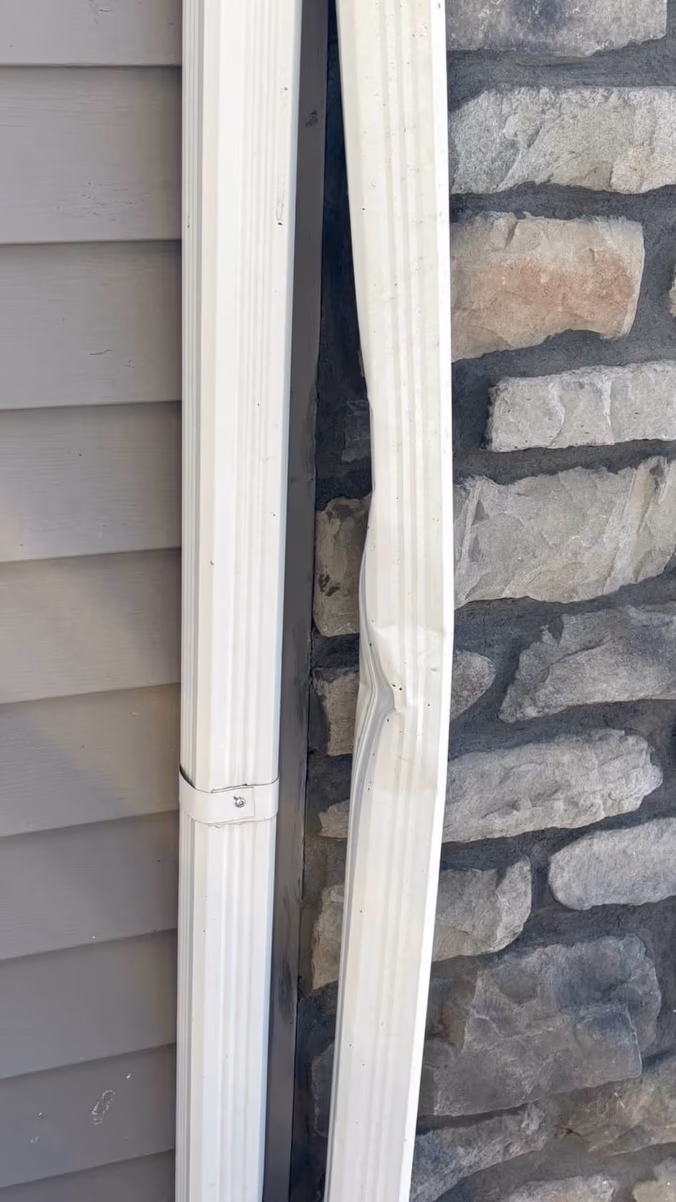 Dented downspout — before repair