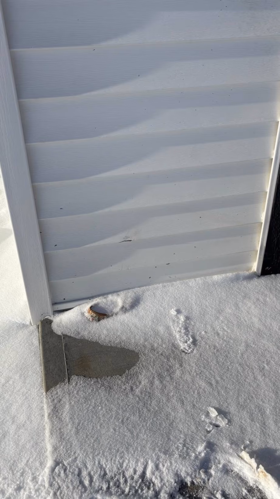 Warped siding panels documented during a damage assessment
